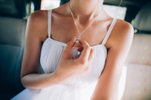 Woman holding her diamond necklace