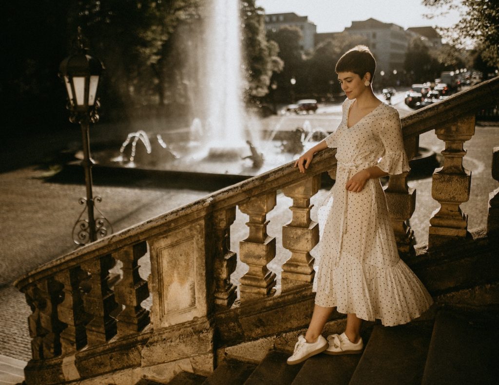 woman in a dress by the stairs