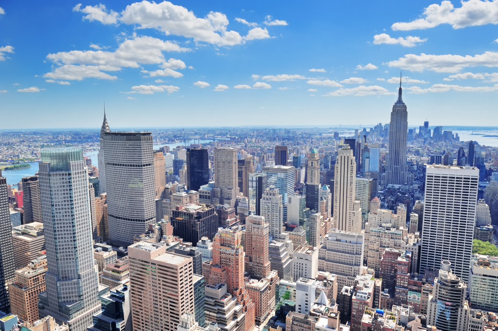 New York City Manhattan midtown aerial panorama view with skyscrapers and blue sky in the day.