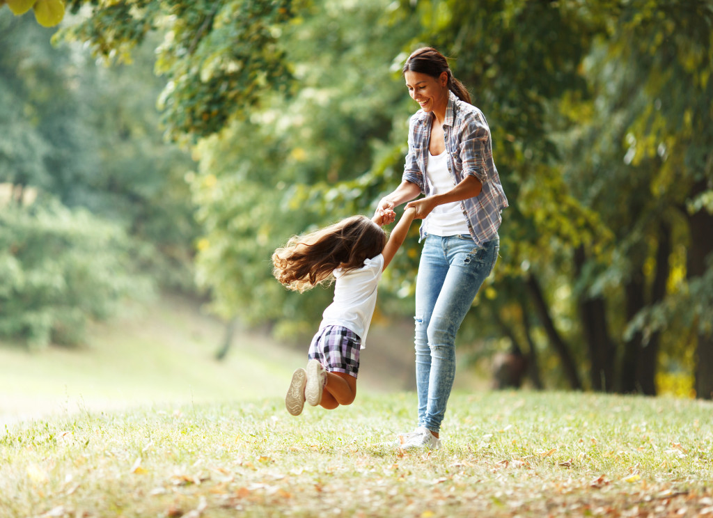 outdoor scene mom playing with daughter