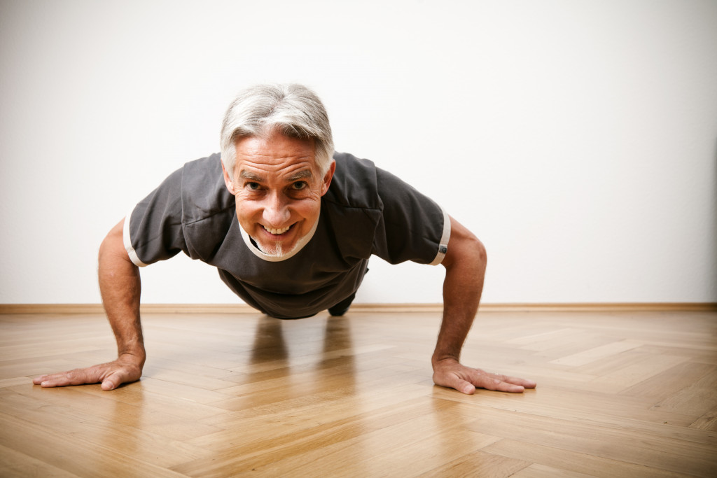 older man doing push up