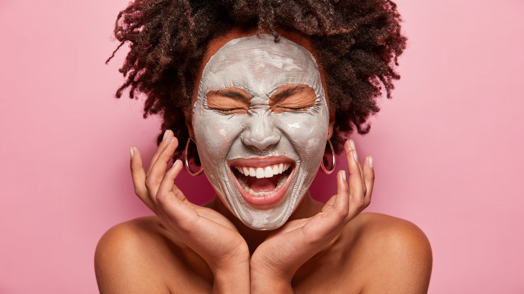 Person with clay mask