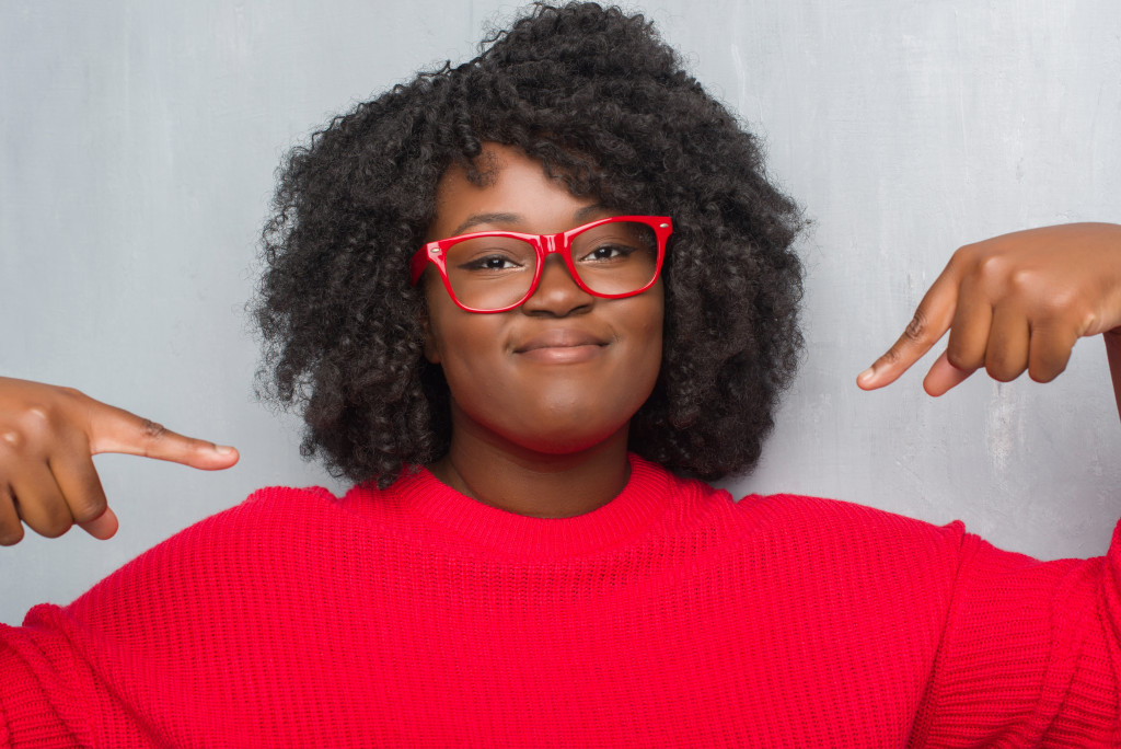 colored woman pointing at herself