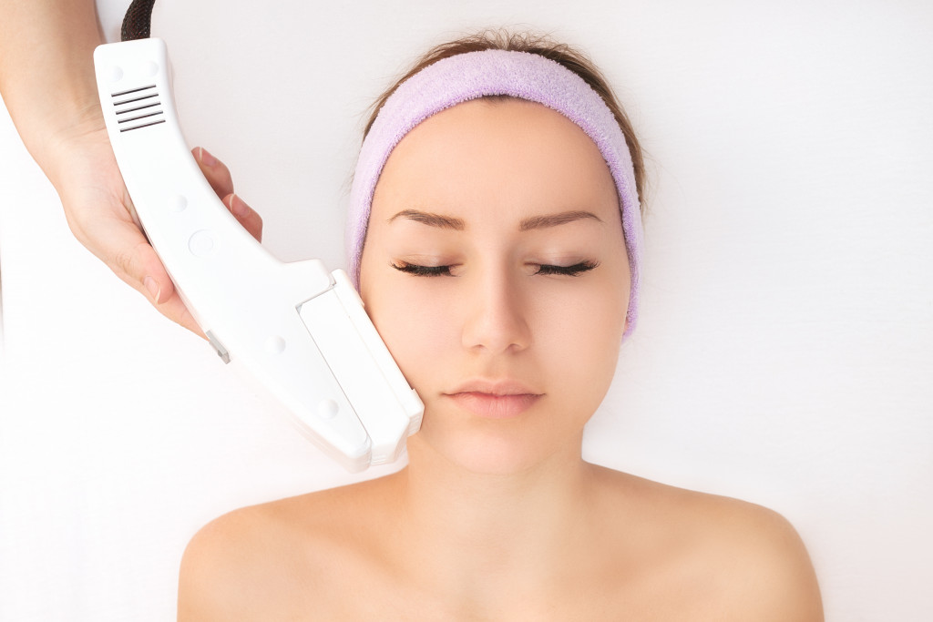 a woman doing a facial treatment