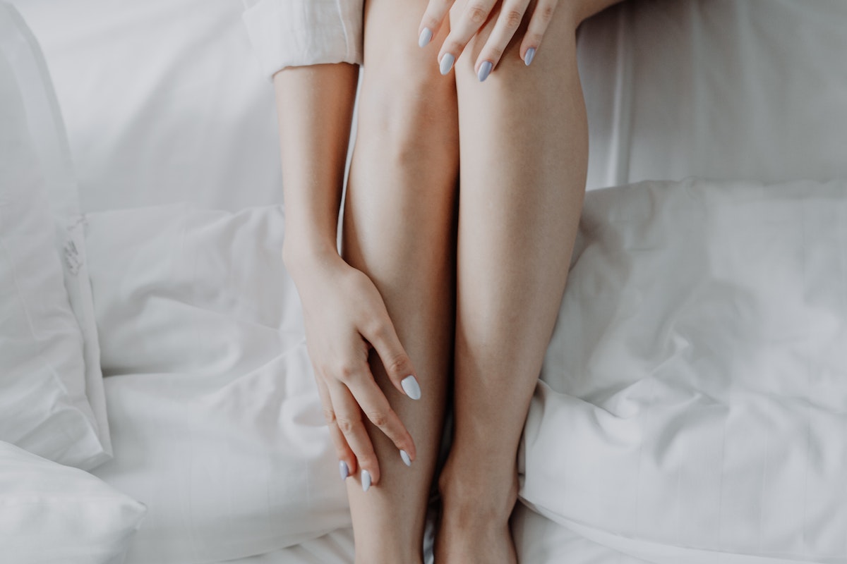 Woman in White Dress Shirt Lying on Bed