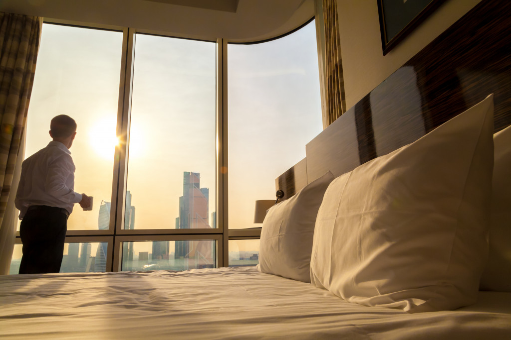 man enjoying the view from his penthouse