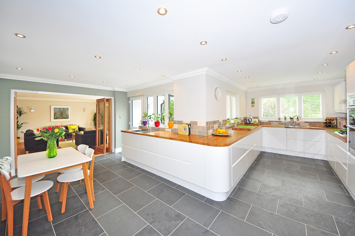 bright colours on the wall and dark tiling on a kitchen
