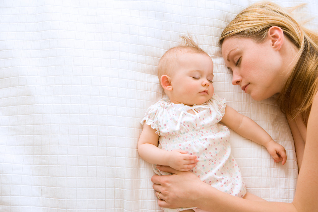 mother asleep with baby boy